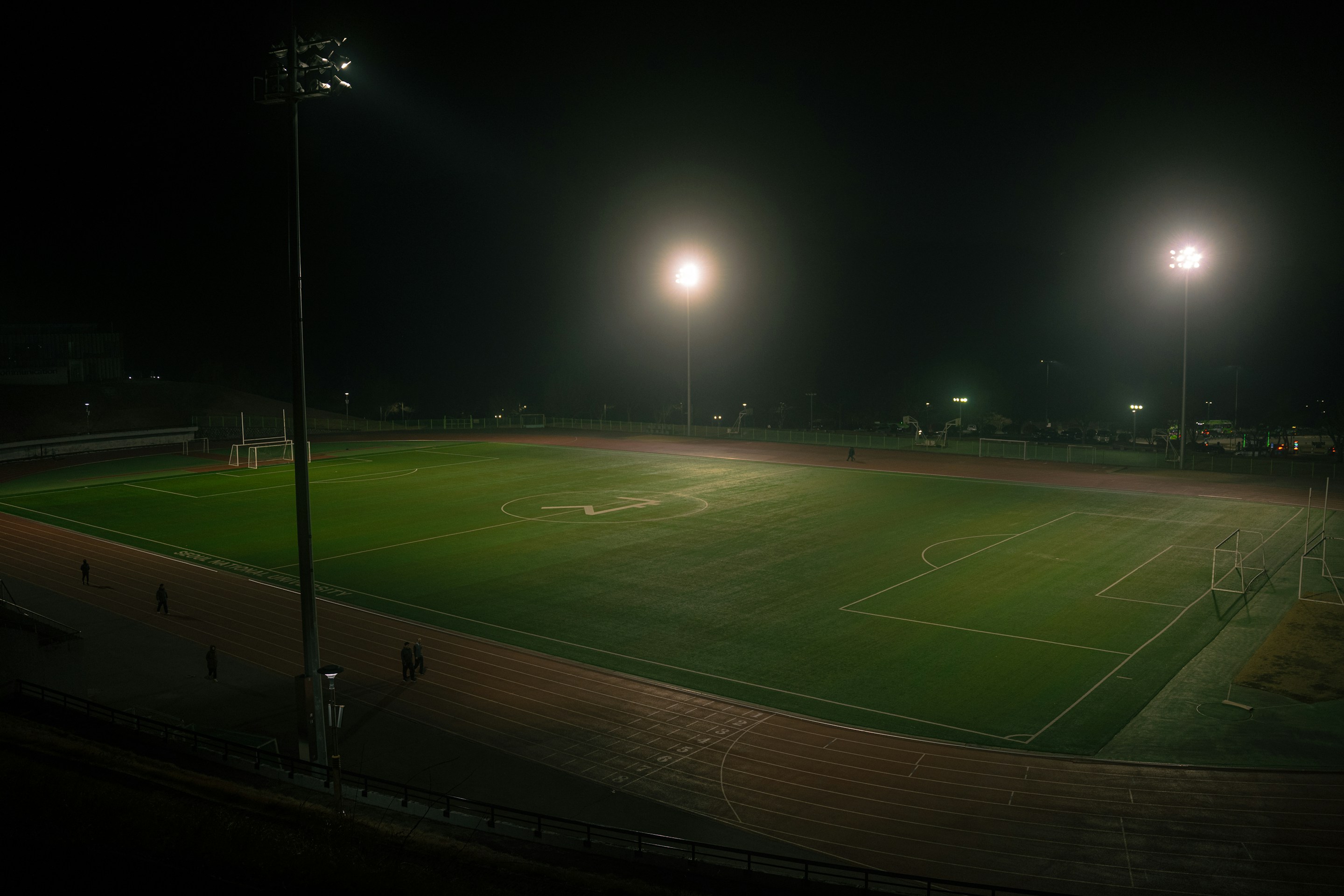 Floodlit soccer field at night